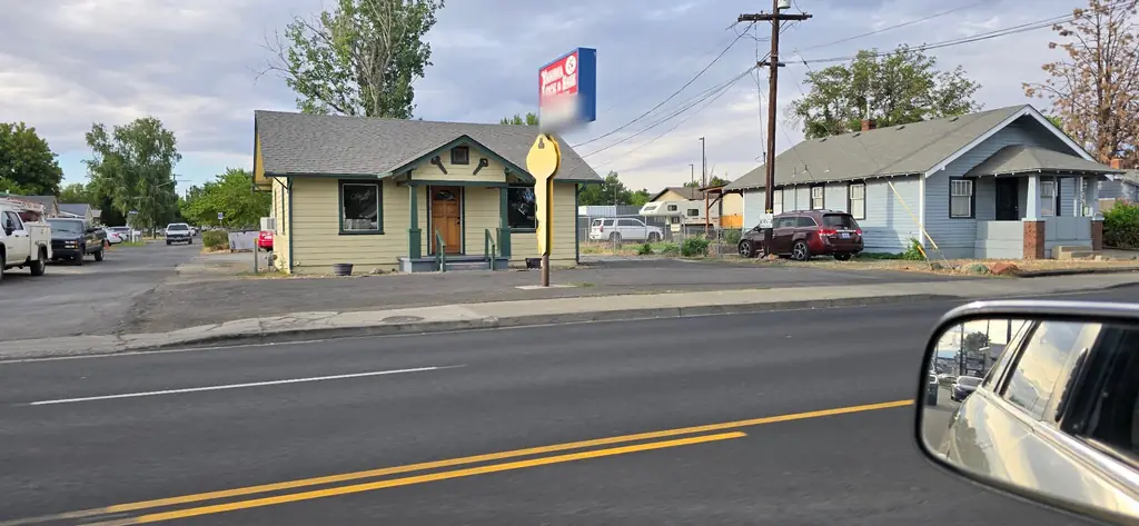 The Yakima Lock & Safe bungalow and its key sign seen from across Nob Hill Blvd
